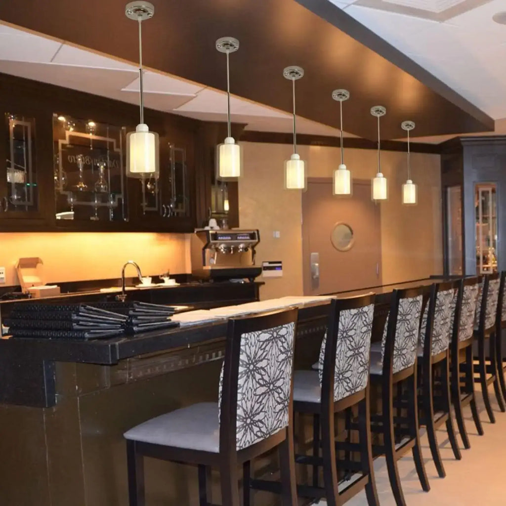 Modern Glass Pendant Light with Chrome Nickel Finish for Kitchen Island in stylish bar setting.