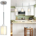 Modern Glass Pendant Light with Chrome Nickel Finish for Kitchen Island illuminating a stylish kitchen island.